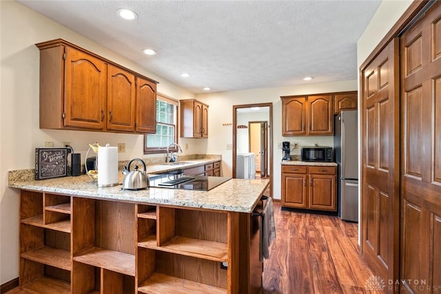 1747 Maple Ln, Beavercreek, OH 45432 - kitchen featuring black appliances, a peninsula, dark wood-type flooring, open shelves, and a sink