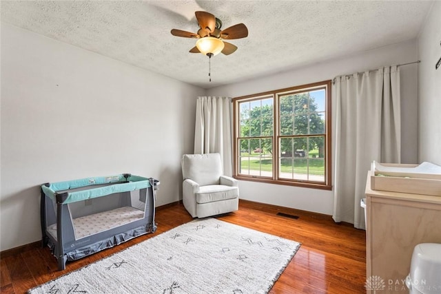 1747 Maple Ln, Beavercreek, OH 45432 - living area featuring wood finished floors, a ceiling fan, a textured ceiling, and baseboards