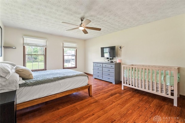 1747 Maple Ln, Beavercreek, OH 45432 - bedroom featuring a textured ceiling, wood finished floors, and ceiling fan