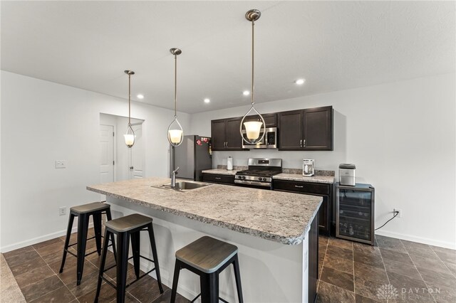1130 Arden Way, Fairborn, OH 45324 - kitchen with appliances with stainless steel finishes, beverage cooler, a sink, baseboards, and a breakfast bar area