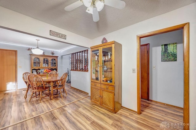 39 Spartan Dr, Oxford, OH 45056 - dining room with light wood-style floors, ceiling fan, a textured ceiling, and baseboards