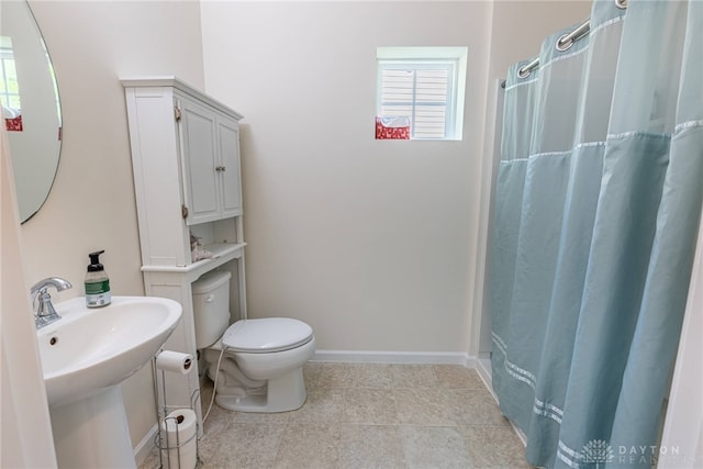 8730 Dowd Ct, Washington Twp, OH 45458 - full bath with toilet, tile patterned flooring, and baseboards
