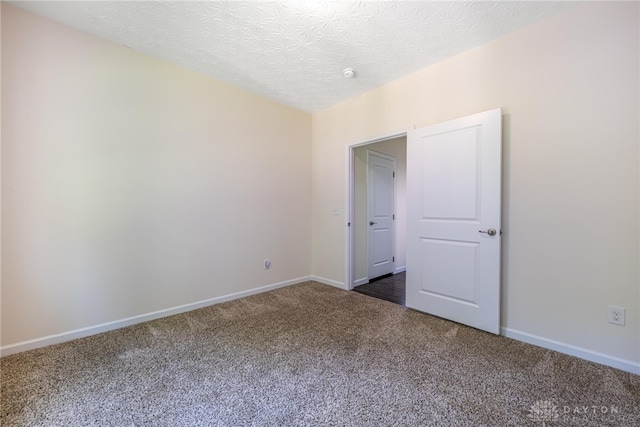 8730 Dowd Ct, Washington Twp, OH 45458 - unfurnished room featuring dark carpet, baseboards, and a textured ceiling