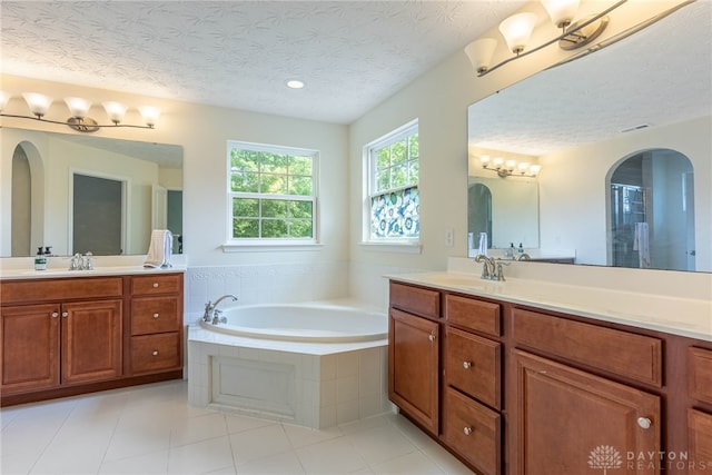 8730 Dowd Ct, Washington Twp, OH 45458 - bathroom with two vanities, a bath, a textured ceiling, tile patterned flooring, and recessed lighting