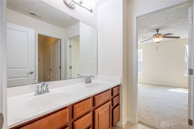 8730 Dowd Ct, Washington Twp, OH 45458 - bathroom with ceiling fan, double vanity, a textured ceiling, and baseboards