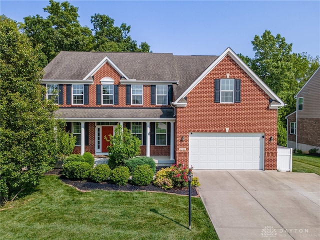 8730 Dowd Ct, Washington Twp, OH 45458 - view of front of house with driveway, brick siding, a front yard, a shingled roof, and an attached garage