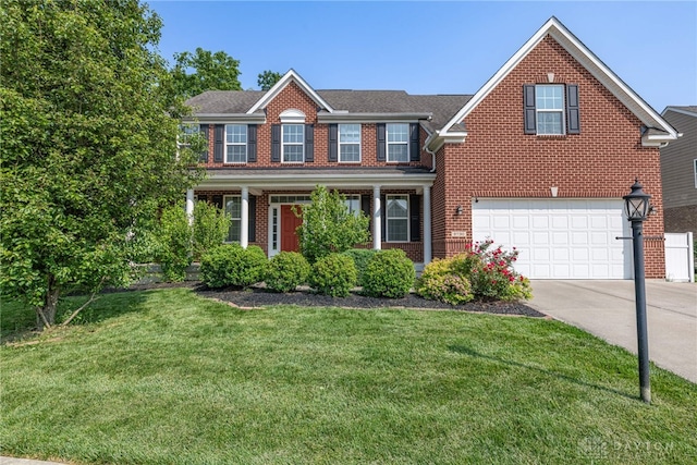 8730 Dowd Ct, Washington Twp, OH 45458 - view of front of house with brick siding, driveway, a front lawn, and an attached garage