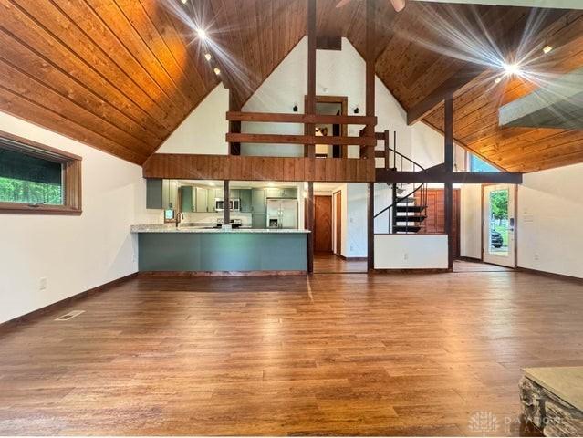 5565 Short Rd, New Carlisle, OH 45344 - unfurnished living room with high vaulted ceiling, wood finished floors, wood ceiling with exposed beams, stairs, and baseboards