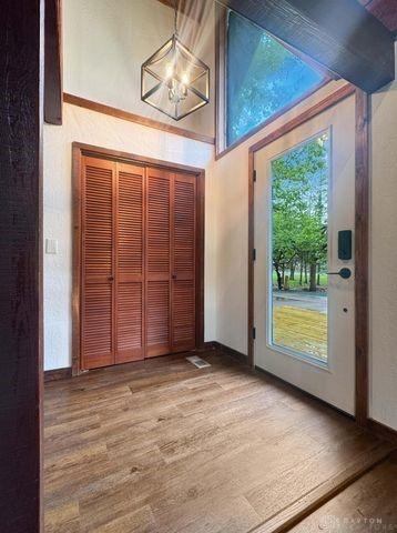 5565 Short Rd, New Carlisle, OH 45344 - entryway with a chandelier, wood finished floors, and baseboards