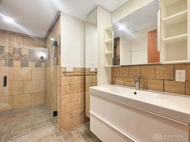 5565 Short Rd, New Carlisle, OH 45344 - full bathroom with a tile shower, vanity, and tile walls