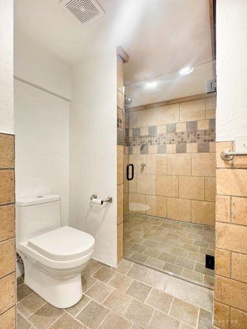5565 Short Rd, New Carlisle, OH 45344 - bathroom with a stall shower, toilet, and recessed lighting
