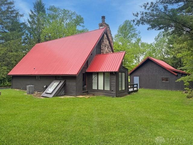 5565 Short Rd, New Carlisle, OH 45344 - rear view of property with a yard, a chimney, cooling unit, and metal roof