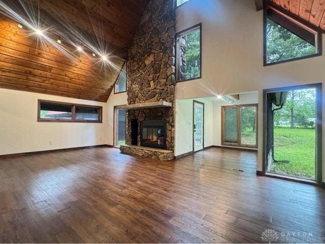 5565 Short Rd, New Carlisle, OH 45344 - unfurnished living room with high vaulted ceiling, wooden ceiling, a fireplace, wood finished floors, and baseboards
