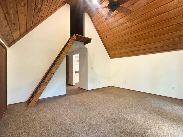 5565 Short Rd, New Carlisle, OH 45344 - unfurnished living room with wooden ceiling, a ceiling fan, carpet floors, and high vaulted ceiling
