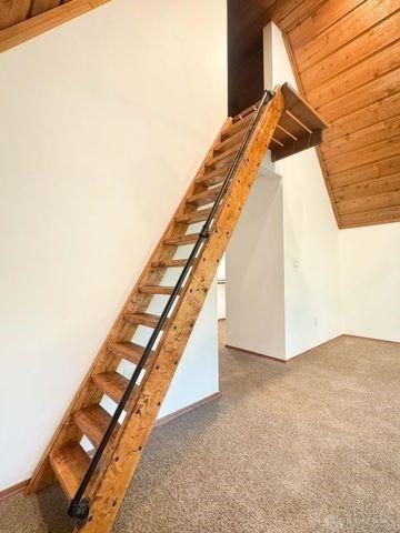 5565 Short Rd, New Carlisle, OH 45344 - stairway featuring wooden ceiling, carpet flooring, lofted ceiling, and baseboards