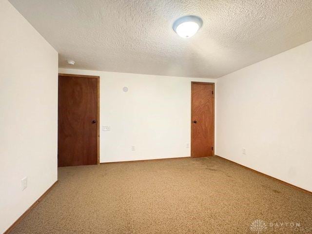 5565 Short Rd, New Carlisle, OH 45344 - carpeted spare room with a textured ceiling