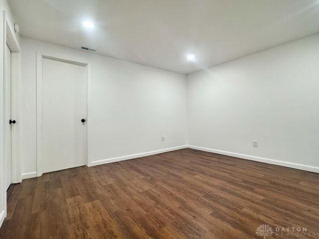 5565 Short Rd, New Carlisle, OH 45344 - empty room with dark wood-style flooring, baseboards, and recessed lighting
