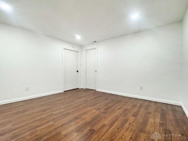 5565 Short Rd, New Carlisle, OH 45344 - unfurnished room featuring dark wood-style flooring, baseboards, and recessed lighting