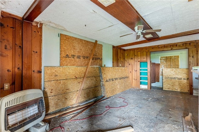 222 S Pike St, New Carlisle, OH 45344 - misc room with heating unit, ceiling fan, and wooden walls