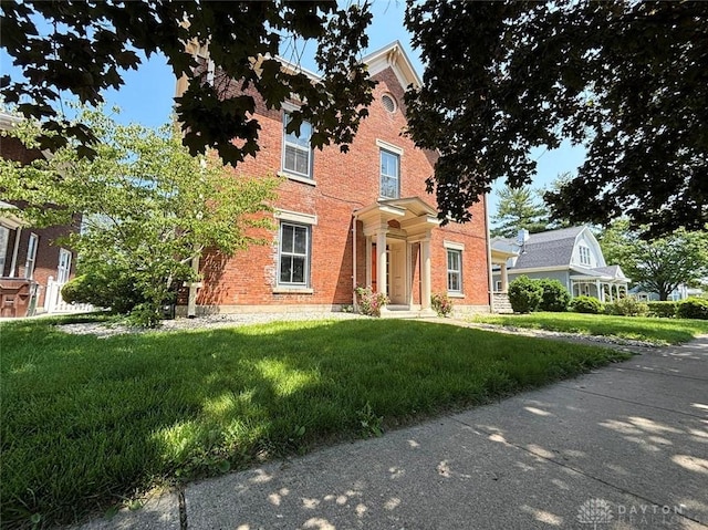 142 W Church St, Xenia, OH 45385 - view of front facade with a front lawn and brick siding