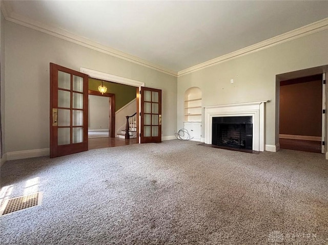 142 W Church St, Xenia, OH 45385 - unfurnished living room with stairs, crown molding, baseboards, carpet flooring, and built in shelves