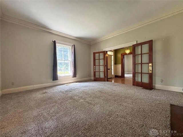 142 W Church St, Xenia, OH 45385 - empty room featuring french doors, crown molding, carpet floors, and baseboards