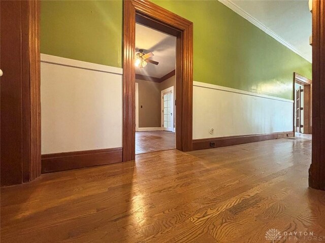 142 W Church St, Xenia, OH 45385 - unfurnished room featuring crown molding, wood finished floors, ceiling fan, and a wainscoted wall