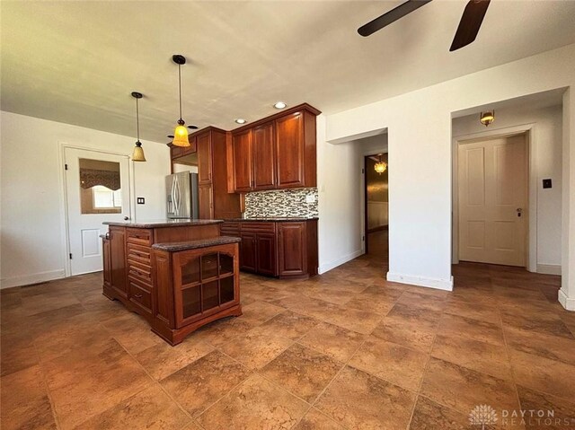 142 W Church St, Xenia, OH 45385 - kitchen featuring a ceiling fan, stainless steel fridge with ice dispenser, baseboards, a center island, and dark countertops