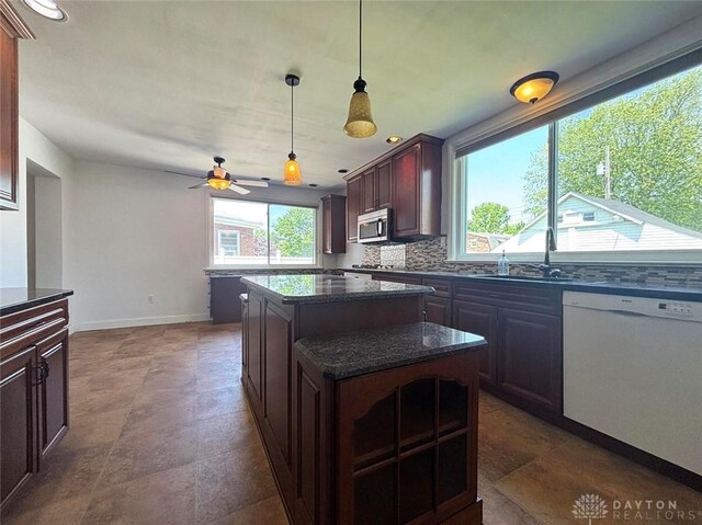 142 W Church St, Xenia, OH 45385 - kitchen with stainless steel microwave, a sink, white dishwasher, a ceiling fan, and baseboards