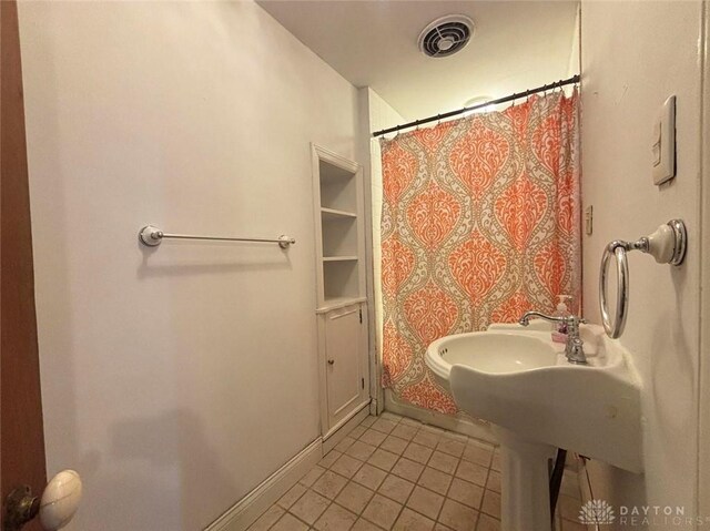 142 W Church St, Xenia, OH 45385 - full bath with tile patterned floors, a shower with curtain, and baseboards