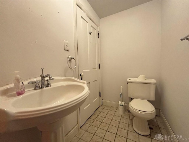 142 W Church St, Xenia, OH 45385 - bathroom with toilet, tile patterned flooring, baseboards, and a sink