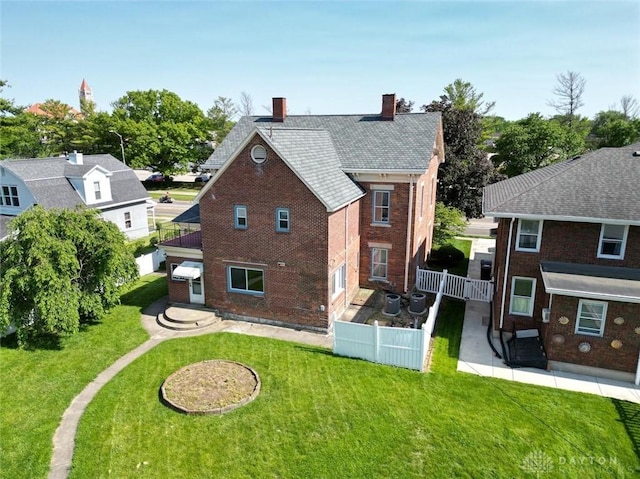 142 W Church St, Xenia, OH 45385 - rear view of house with a patio, brick siding, and a chimney
