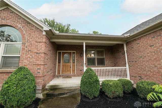 9062 Adam Ln, Waynesville, OH 45068 - view of exterior entry with brick siding and covered porch