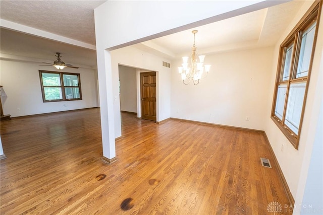 9062 Adam Ln, Waynesville, OH 45068 - unfurnished room featuring wood finished floors, a chandelier, a ceiling fan, and baseboards
