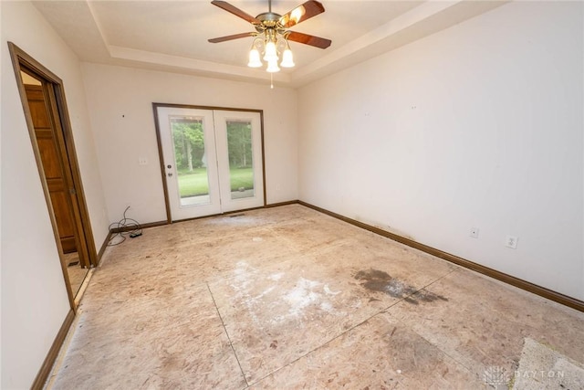 9062 Adam Ln, Waynesville, OH 45068 - spare room with a tray ceiling, baseboards, and ceiling fan