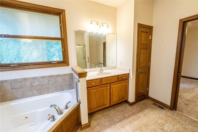 9062 Adam Ln, Waynesville, OH 45068 - bathroom featuring a whirlpool tub, vanity, tile patterned flooring, a shower stall, and baseboards