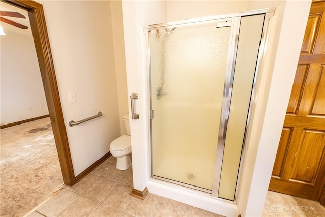 9062 Adam Ln, Waynesville, OH 45068 - bathroom with a shower stall, toilet, a ceiling fan, tile patterned floors, and baseboards