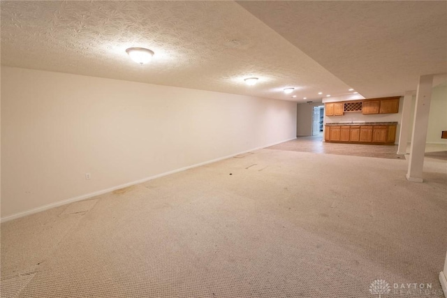 9062 Adam Ln, Waynesville, OH 45068 - finished below grade area featuring light colored carpet, baseboards, a textured ceiling, and recessed lighting
