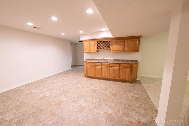9062 Adam Ln, Waynesville, OH 45068 - kitchen featuring recessed lighting, baseboards, stone counters, and a sink