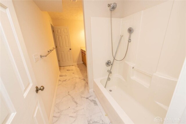 9062 Adam Ln, Waynesville, OH 45068 - bathroom with marble look tiles,  shower combination, baseboards, and vanity