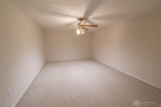 9062 Adam Ln, Waynesville, OH 45068 - empty room with ceiling fan, light colored carpet, baseboards, and a textured ceiling