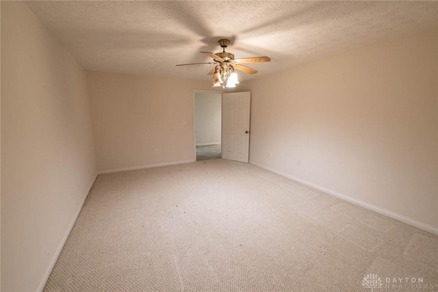 9062 Adam Ln, Waynesville, OH 45068 - unfurnished room with a ceiling fan, light colored carpet, baseboards, and a textured ceiling