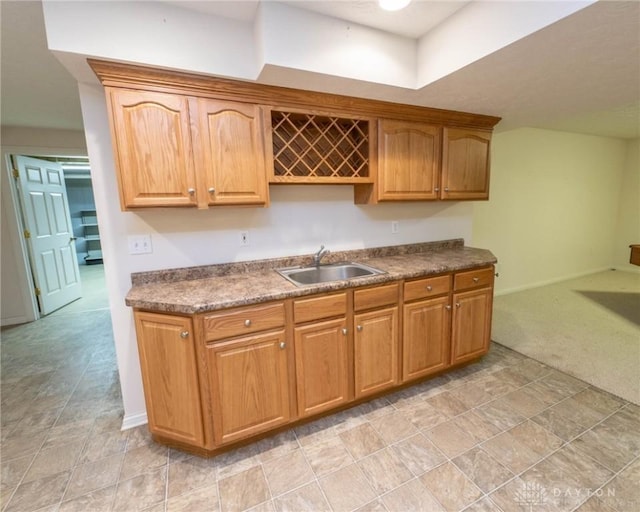 9062 Adam Ln, Waynesville, OH 45068 - kitchen with a sink, dark countertops, baseboards, and light carpet