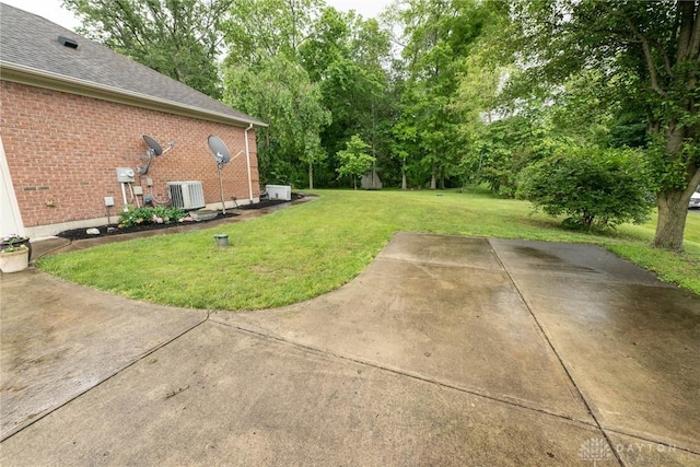 9062 Adam Ln, Waynesville, OH 45068 - view of grassy yard featuring central AC and view of wooded area