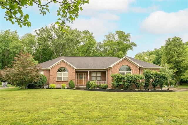 9062 Adam Ln, Waynesville, OH 45068 - ranch-style house featuring a front yard, a porch, brick siding, and a shingled roof