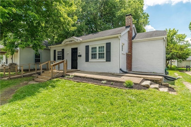 3108 Ohio Ave, Middletown, OH 45042 - view of front of house featuring stucco siding, a chimney, a front lawn, and a shingled roof