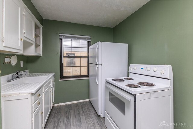515 Aberdeen Ave, Dayton, OH 45419 - kitchen with white appliances, white cabinets, light countertops, wood finished floors, and a textured ceiling