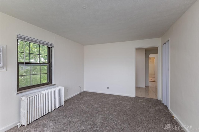 515 Aberdeen Ave, Dayton, OH 45419 - carpeted spare room with radiator heating unit and arched walkways