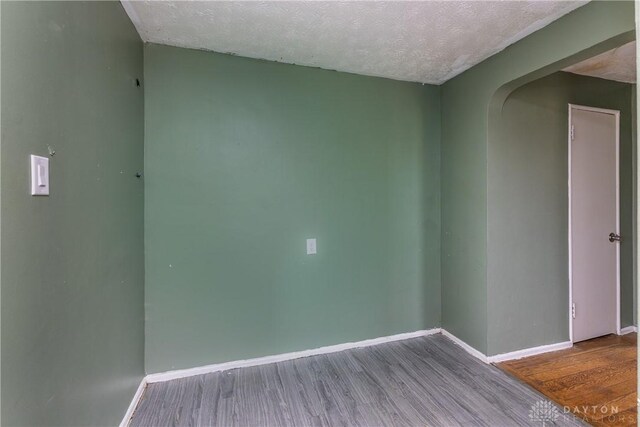 515 Aberdeen Ave, Dayton, OH 45419 - spare room with arched walkways, wood finished floors, and a textured ceiling