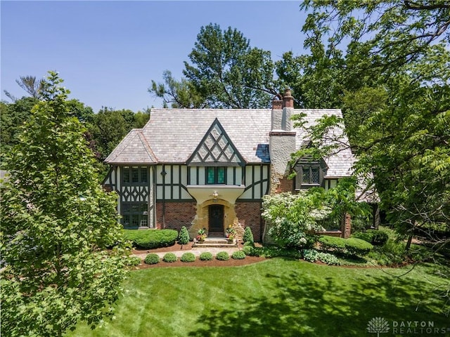 1500 Ridgeway Rd, Oakwood, OH 45419 - tudor home with a chimney, a front yard, stucco siding, and a high end roof